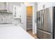 Bright kitchen featuring stainless steel appliances, white cabinets, and walk in pantry at 16489 Silver Brook Way, Winter Garden, FL 34787