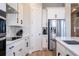 Bright kitchen featuring white cabinets, stainless steel appliances, and modern countertops at 16489 Silver Brook Way, Winter Garden, FL 34787