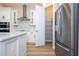 Bright kitchen featuring stainless steel appliances, white cabinets, and walk in pantry at 16489 Silver Brook Way, Winter Garden, FL 34787