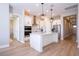 Open-concept kitchen with white cabinetry, stainless appliances, and modern island at 16489 Silver Brook Way, Winter Garden, FL 34787