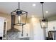 Modern decorative kitchen lighting and white cabinets at 16489 Silver Brook Way, Winter Garden, FL 34787