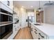 Modern kitchen featuring stainless steel appliances, white cabinets, and an island with a sink at 16489 Silver Brook Way, Winter Garden, FL 34787