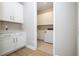 Laundry room with cabinets, quartz countertops, sink, and tiled floor at 16489 Silver Brook Way, Winter Garden, FL 34787