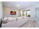 Relaxing living room with a soft sofa, television, and natural light from the window at 16489 Silver Brook Way, Winter Garden, FL 34787