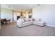 Open-concept living room flows into kitchen, showcasing a comfortable sectional sofa and modern pendant lighting at 16489 Silver Brook Way, Winter Garden, FL 34787