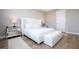 Luxurious primary bedroom with tray ceiling, white upholstered bed, mirrored nightstands, and bench at 16489 Silver Brook Way, Winter Garden, FL 34787