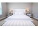 Bright primary bedroom featuring a plush, upholstered bed, bench, and mirrored nightstands at 16489 Silver Brook Way, Winter Garden, FL 34787