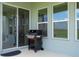 Relaxing outdoor patio featuring windows and a sliding glass door leading to a grassy backyard at 16489 Silver Brook Way, Winter Garden, FL 34787