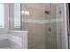 Modern glass enclosed shower with beige tiling and chrome fixtures at 16489 Silver Brook Way, Winter Garden, FL 34787