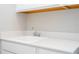 Close-up of the utility sink with white quartz countertops and chrome faucet at 16489 Silver Brook Way, Winter Garden, FL 34787