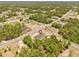 An aerial view showcases the home's location on a corner lot, surrounded by lush greenery and other residences at 17762 Sw 33Rd Ter, Ocala, FL 34473