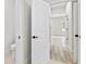 Hallway leading to a room with wood-look flooring and natural light at 17762 Sw 33Rd Ter, Ocala, FL 34473