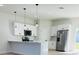Modern kitchen boasts stainless steel appliances, white cabinets, and quartz countertops at 17762 Sw 33Rd Ter, Ocala, FL 34473
