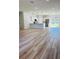 Bright open-concept living space flows into a modern kitchen, featuring sleek hardwood floors at 17762 Sw 33Rd Ter, Ocala, FL 34473
