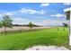 Expansive backyard showcasing a lush green lawn and secure black chain-link fence for privacy and safety at 1805 Kingsmill Dr, Bartow, FL 33830