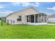 Well-maintained backyard features a screened-in lanai and lush lawn, perfect for outdoor enjoyment and relaxation at 1805 Kingsmill Dr, Bartow, FL 33830