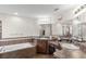 Bathroom featuring double sinks, a soaking tub, and neutral tile design at 1805 Kingsmill Dr, Bartow, FL 33830