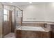 Well-lit bathroom with a glass-enclosed shower and a separate soaking tub at 1805 Kingsmill Dr, Bartow, FL 33830