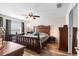 Spacious bedroom with a large window and traditional decor, including a carved wood bed frame at 1805 Kingsmill Dr, Bartow, FL 33830