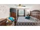 Bedroom featuring a large bed, modern ceiling fan, and bright natural light at 1805 Kingsmill Dr, Bartow, FL 33830