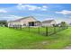 Spacious backyard surrounded by a black chain-link fence, offering privacy and a large area for recreation at 1805 Kingsmill Dr, Bartow, FL 33830