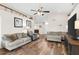 Spacious living room with wood flooring, high ceilings, and stylish furniture at 1805 Kingsmill Dr, Bartow, FL 33830