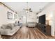 Spacious living room with wood flooring, high ceilings, and stylish furniture at 1805 Kingsmill Dr, Bartow, FL 33830