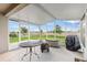 Covered screened patio offers outdoor entertaining with views of the backyard and fencing at 1805 Kingsmill Dr, Bartow, FL 33830