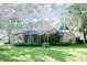Expansive backyard featuring well-maintained lawn, screened patio and mature landscaping at 2102 Applegate Dr, Ocoee, FL 34761