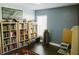 Cozy bedroom with ample bookshelves, natural light, and hardwood floors at 2102 Applegate Dr, Ocoee, FL 34761