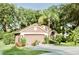Charming one-story home with attached garage, landscaped yard, and mature trees at 2102 Applegate Dr, Ocoee, FL 34761