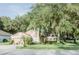 Well-maintained single-story home with lush landscaping and a cozy front entrance at 2102 Applegate Dr, Ocoee, FL 34761