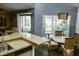 Kitchen with granite countertops open to a dining area with views to the outdoors at 2102 Applegate Dr, Ocoee, FL 34761