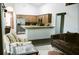 Open concept living room and kitchen with stainless steel appliances and granite countertops at 2102 Applegate Dr, Ocoee, FL 34761