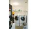 Functional laundry room featuring modern washer and dryer units, plus shelving for storage at 2102 Applegate Dr, Ocoee, FL 34761