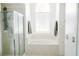 Luxurious main bathroom with soaking tub, walk-in shower, and abundant natural light at 2102 Applegate Dr, Ocoee, FL 34761