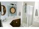 Bright bathroom featuring vanity, shower, patterned tile, and decorative mirrors at 2102 Applegate Dr, Ocoee, FL 34761