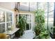 Screened patio with lush greenery and outdoor seating area at 2102 Applegate Dr, Ocoee, FL 34761