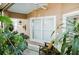Cozy screened patio featuring neutral colors, tile floors, and comfortable rocking chair at 2102 Applegate Dr, Ocoee, FL 34761