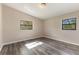 Bedroom with attractive wood-look flooring and natural light from the two windows at 212 Homewood Dr, Sanford, FL 32773