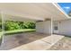Convenient carport attached to home offers ample covered parking with easy access and adjacent green space, great for outdoor activities at 212 Homewood Dr, Sanford, FL 32773