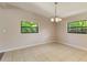 Airy dining room with neutral walls, tile floors, and bright natural light shining through the windows creates a welcoming atmosphere at 212 Homewood Dr, Sanford, FL 32773