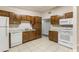 Spacious kitchen features white appliances, wooden cabinets and light countertops creating a functional and inviting cooking area at 212 Homewood Dr, Sanford, FL 32773