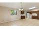 Bright kitchen features tile flooring, brown cabinets, and a large window for natural light at 212 Homewood Dr, Sanford, FL 32773