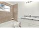 Bathroom with tile surround, white vanity, and shower-tub combo provides convenience and comfort at 2417 Cedar Ave, Sanford, FL 32771