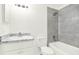 Bright bathroom features a gray tile shower and updated vanity with granite countertop at 2417 Cedar Ave, Sanford, FL 32771