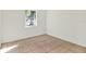 Bright bedroom features a window providing natural light and tile flooring at 2417 Cedar Ave, Sanford, FL 32771