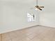 A bright bedroom featuring tiled floors, a ceiling fan, and a window at 2417 Cedar Ave, Sanford, FL 32771