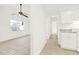 Open-concept layout featuring tiled floors, a ceiling fan, and a view into the bright kitchen at 2417 Cedar Ave, Sanford, FL 32771