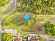 Aerial view of community park with walking paths, playground and splash pad surrounded by green space at 2506 Sw 158Th Lane Rd, Ocala, FL 34473